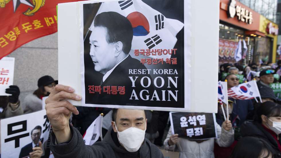 epaselect epa12756269 Supporters of impeached former South Korean President Yoon Suk Yeol shout slogans as they rally outside the Seoul Central District Court in Seoul, South Korea, 19 February 2026. A court sentenced former President Yoon Suk Yeol to life imprisonment on 19 February, on charges of being the alleged leader of a rebellion related to his 03 December 2024 decleration of martial law.  EPA/JEON HEON-KYUN