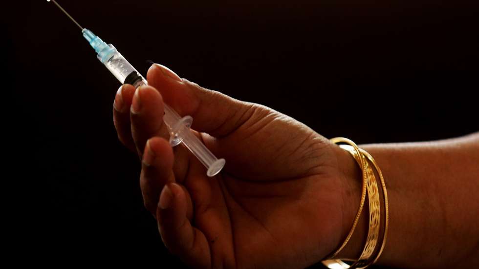 epaselect epa08941004 A syringe with a first dose of a Covid-19 vaccine shot, manufactured by the Serum Institute of India at Government General Hospital in Jayanagar Bangalore, India, 16 January 2021. One of the world's biggest and nationwide COVID-19 vaccination drive was launched by Indian prime minister Narendra Modi and aimed at inoculating 30 million people in first drive that include front line workers like Accredited Social Health Activist (ASHA) doctors, MBBS students, nurses etc.  EPA/JAGADEESH NV