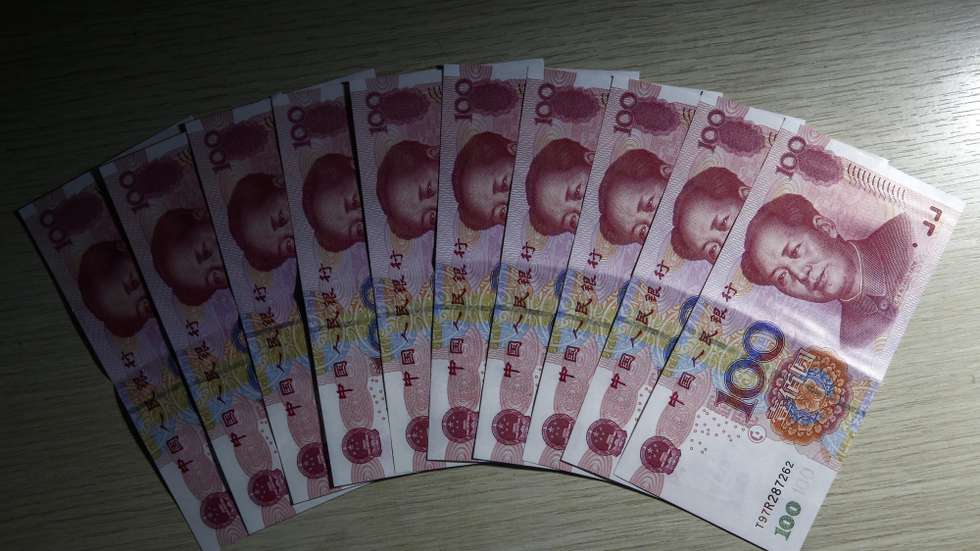 epa05161868 A photo illustration of 100 Chinese Renminbi, or Yuan, bills arranged on a table in Beijing, China, 15 February 2016. 
According to data gathered by Bloomberg, the Yuan currency had appreciated by as much 1.25 percent, the highest since July 2005, to 6.4954 a dollar in Shanghai.  EPA/ROLEX DELA PENA