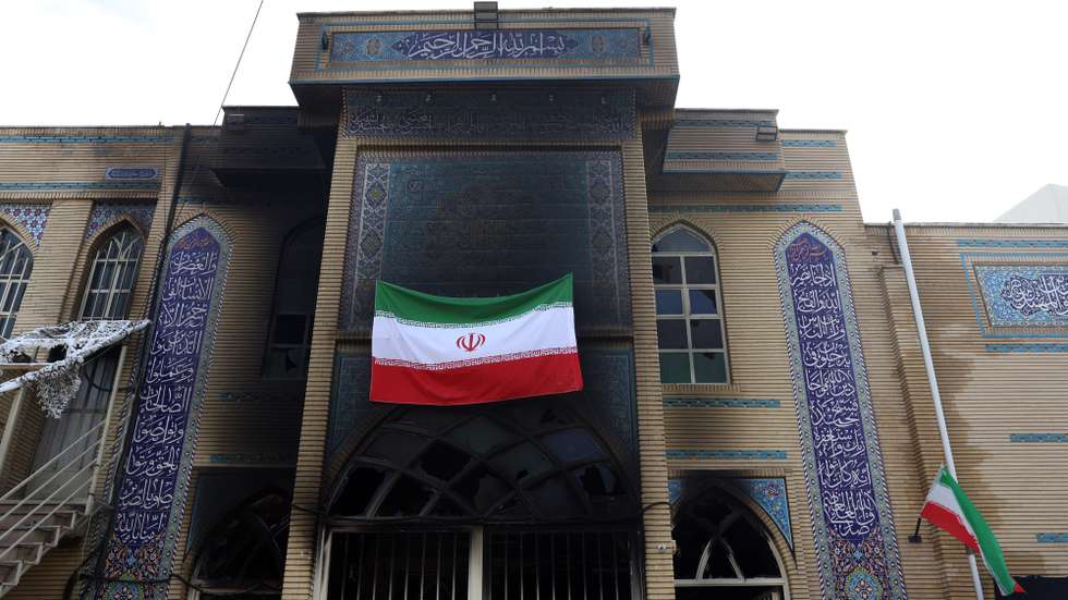 epa12667167 Iran's national flag hangs from a mosque which was damaged by fire during recent anti-government protests, in Tehran, Iran, 21 January 2026. Iran is experiencing a nationwide internet blackout that began on 08 January 2026, amid an intensifying wave of anti-government protests.  EPA/ABEDIN TAHERKENAREH