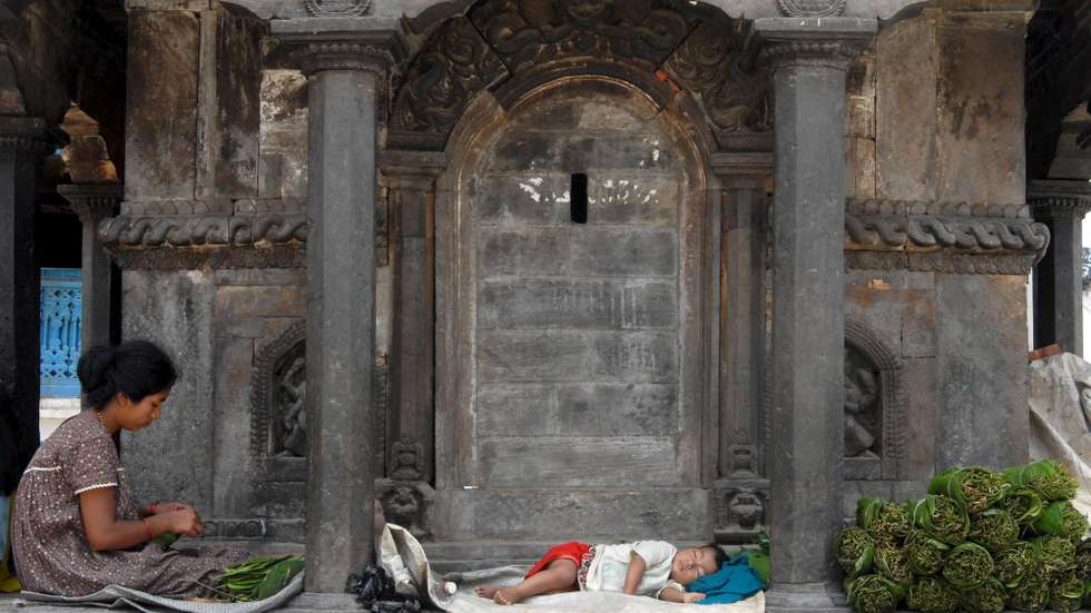 epa01042091 A Nepalese mother prepares food while her child takes a nap during a hot day in Kathmandu, Nepal 18 June 2007. Nepal registered a record high temperature of 44 degrees Celsius in Eastern Nepal and 33 degrees in the capital of Kathmandu this week. A heat wave in Eastern Nepal has already affected the livelihoods of a large number of poverty-stricken families who depend on daily wage outdoor labours.  EPA/NARENDRA SHRESTHA