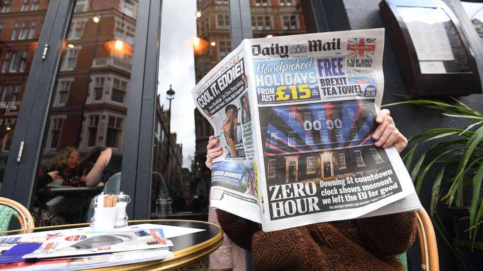 epa08184759 A newspaper reader with the Daily Mail in a cafe in London, Britain, 01 February 2020. Britain has officially left the EU on 31 January 2020, beginning an eleven month transition period.  EPA/FACUNDO ARRIZABALAGA