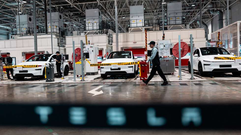 epa12889777 Employees work in the Tesla Gigafactory assembly line, during a government-organized visit, in Shanghai, China, 14 April 2026. Tesla entered the Chinese mainland market in 2013, and on 07 January, 2019, Gigafactory Shanghai broke ground, becoming its first manufacturing facility outside the US by 30 December of the same year. The factory had started delivering 'Made-in-China' Model 3 vehicles. In 2025, Gigafactory Shanghai delivered 851,000 electric vehicles, over half of Tesla's global deliveries that year. The factory serves two roles: manufacturing for the Chinese market and acting as a global export hub. It produces the Model 3, Model Y, and the six-seat Model Y La SUV, which was unveiled in August 2025. China's advanced manufacturing ecosystem and supply chain make Gigafactory Shanghai one of the world's most competitive auto manufacturing sites.  EPA/ALEX PLAVEVSKI