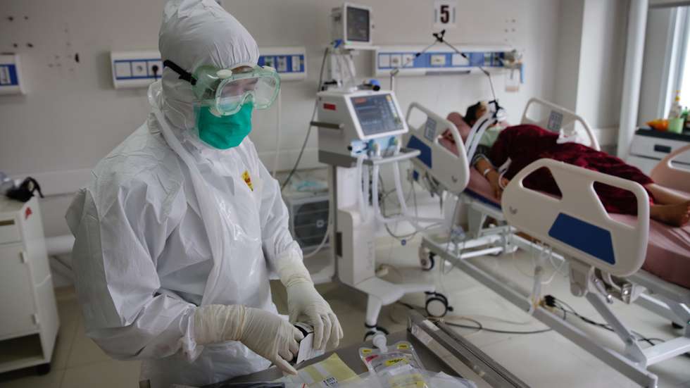 epa09294741 An intensive care unit (ICU) worker conducts a routine medical checkup for a COVID-19 patient at Bogor City Hospital, Indonesia, 23 June 2021. Indonesia has recorded over two million COVID-19 cases since the beginning of the pandemic.  EPA/ADI WEDA