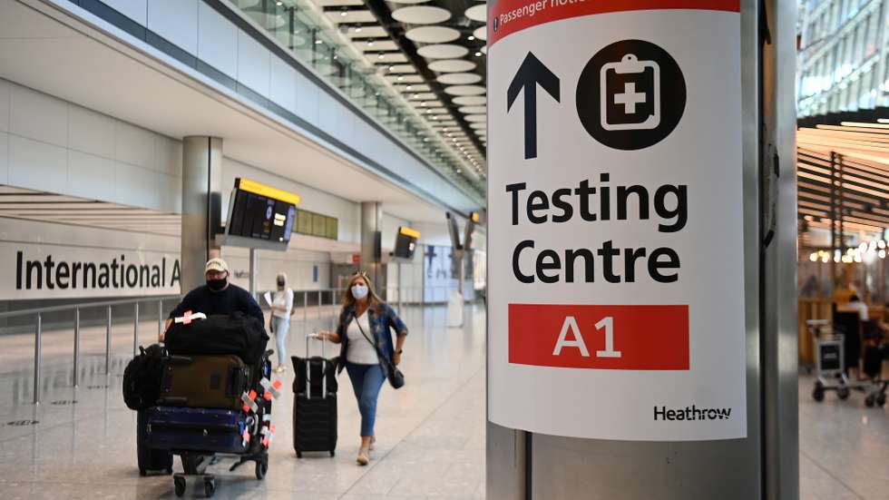 epa09254986 Travellers at Heathrow airport in London, Britain, 08 June 2021. Extra flights to Britain have been departing Portugal as holidaymakers scrambled to leave on the last day before the country moved to the amber travel list. Many travellers missed the deadline and will have to quarantine for up to ten days.  EPA/ANDY RAIN