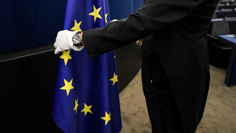epa07286224 An usher places the european flag at the European Parliament in Strasbourg, France, 15 January 2019, after the 	 commemoration of twenty years of the Euro.  EPA/PATRICK SEEGER
