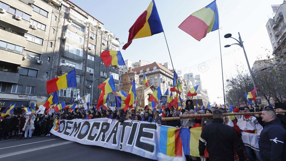 epa11820260 Romanians shout slogans and wave national flags during a protest against the cancellation of the first round of presidential elections in downtown Bucharest, Romania, 12 January 2025. The ultra-nationalist party Alliance for the Union of Romanians (AUR) organized the protest in response to the Romanian Constitutional Court's (CCR) decision to annul the presidential elections held in December 2024, demanding the reversal of the CCR's ruling and the continuation of the second round of the presidential elections.  EPA/ROBERT GHEMENT