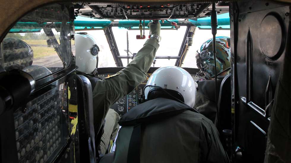 epa04544689 Indonesian Air Force, Major Pilot Suryo (L) and Co Pilot Ravi (R) look out of the cockpit windows of the Super Puma NAS 332 helicopter during a search operation over Kumai Bay, Central Borneo, Pangkalan Bun, Indonesia, 02 January 2015. Indonesian rescuers retrieved two more bodies from the sea on 01 January, bringing the total number recovered to nine out of the 162 people on board the flight, but the search to recover more victims from the AirAsia plane crash was hampered by bad weather, the recue chief said. AirAsia Indonesia flight QZ8501 crashed into the Java Sea on 28 December with 162 people on board, about halfway through a two-hour flight between Surabaya, Indonesia's second largest city, and Singapore.  EPA/BAGUS INDAHONO / POOL