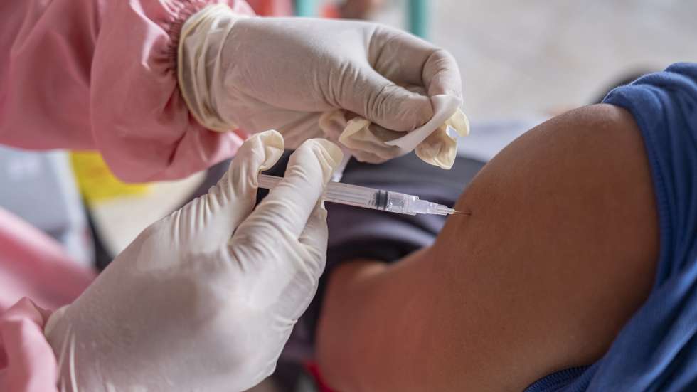 epa09272233 A man receives a shot of a COVID-19 vaccine during a mass COVID-19 vaccination drive at a tourist area of Sanur in Bali, Indonesia, 15 June 2021. Bali's government is speeding up its vaccination process in major tourist areas as the Indonesian government planned to reopen the resort islands of Bali to foreign tourists by the end of July 2021.  EPA/MADE NAGI