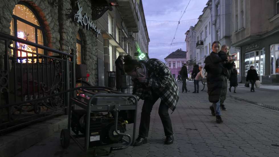 epa11775574 A person operates a generator amid a power cut in Uzhgorod, Western Ukraine, 13 December 2024. Power cuts have been reported across Ukraine after Russian forces launched a large-scale country-wide attack on the night between 12 and 13 December 2024, with around 90 missiles and 190 unmanned aerial vehicles (UAVs), according to Ukrainian President Zelensky.  EPA/IGOR TKACHENKO