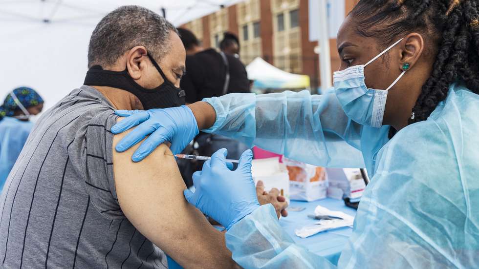 epa09248140 Registered Nurse Sheba Phillip (R) administers a COVID-19 vaccination shot to J. Hernandez (L), of the Bronx, at a vaccination site outside of the Bronx Writing Academy in the Bronx borough of New York, New York, USA, 04 June 2021. New York City is pushing to get more younger people vaccinated as the city recently announced plans to return to full-time in-school learning for students in the fall.  EPA/JUSTIN LANE