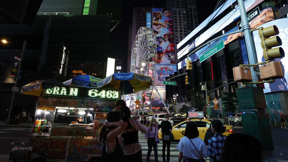 epa09429716 A general view of Times Square and the 110 feet (33.5 meters) tall Times Square Wheel, a ferris wheel which was constructed in Times Square in New York, New York, USA, 25 August 2021. The attraction will operate until 12 September.  EPA/JASON SZENES