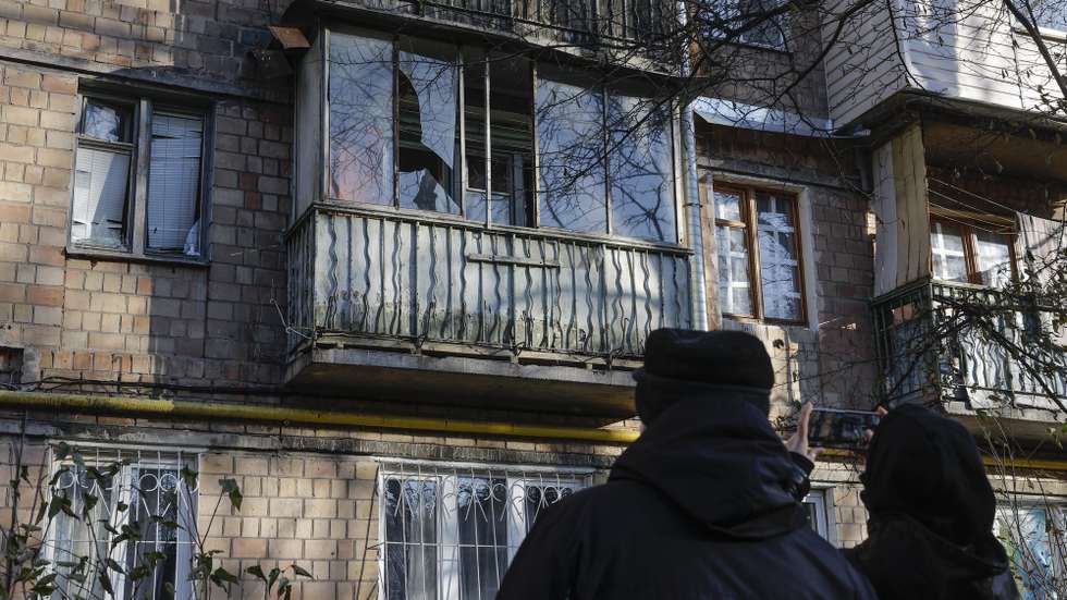 epa10993832 People view shattered windows of an apartment building damaged during drone strikes in Kyiv, Ukraine 25 November 2023. Ukraine's Air Force Command of the Armed Forces said it downed 71 of 75 drones in an overnight attack, 25 November, in what Kyiv authorities called the most intense attack on the capital since the start of the invasion.  Russian troops entered Ukrainian territory in February 2022, starting a conflict that has provoked destruction and a humanitarian crisis.  EPA/SERGEY DOLZHENKO