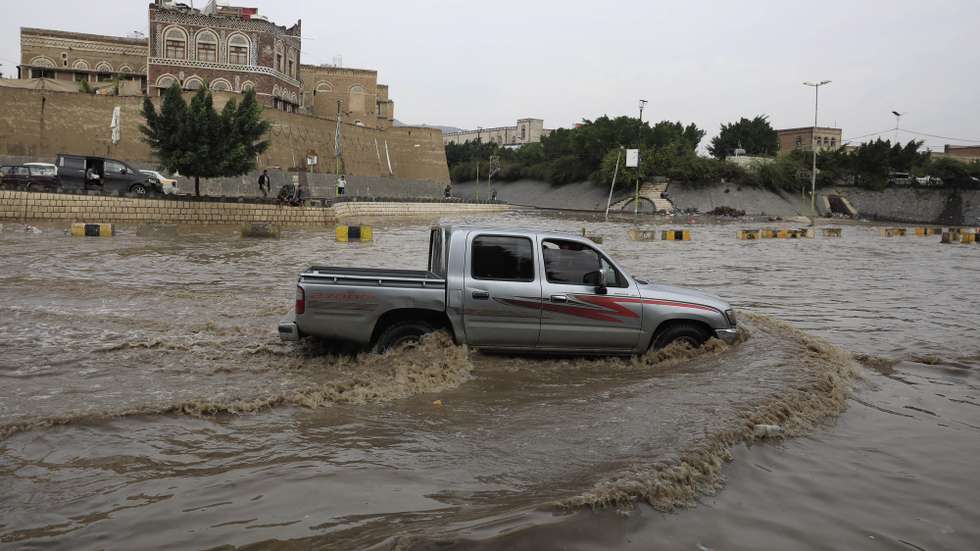 epa11553425 A vehicle drives through a flooded street following heavy rains in Sana'a, Yemen, 17 August 2024. Heavy rains and flash floods have hit large parts of Yemen over the past two weeks, leaving about 98 people killed and over 600 others injured, according to a statement by the United Nations.  EPA/YAHYA ARHAB