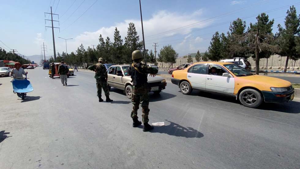 epa09445487 Taliban forces, wearing uniform in colors of former Afghan Army, stand guard at a road side check point in Kabul, Afghanistan, 03 September 2021. The Taliban on 02 September, said they have completed the consultation on government formation but were yet to decide who would head the new Afghan administration that they would announce very soon. The last group of American soldiers departed Kabul around midnight on Monday, ending the longest of US wars that began after the Sep.11, 2001 attacks in America.  EPA/STRINGER