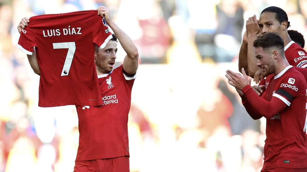 epa10947502 Diogo Jota (L) of Liverpool celebrates after scoring the 1-0 lead holding the jersey of teammate Luis Diaz during the English Premier League match between Liverpool and Nottingham Forest in Liverpool, Britain, 29 October 2023.  EPA/PETER POWELL No use with unauthorized audio, video, data, fixture lists, club/league logos, 'live' services' or as NFTs. Online in-match use limited to 120 images, no video emulation. No use in betting, games or single club/league/player publications.