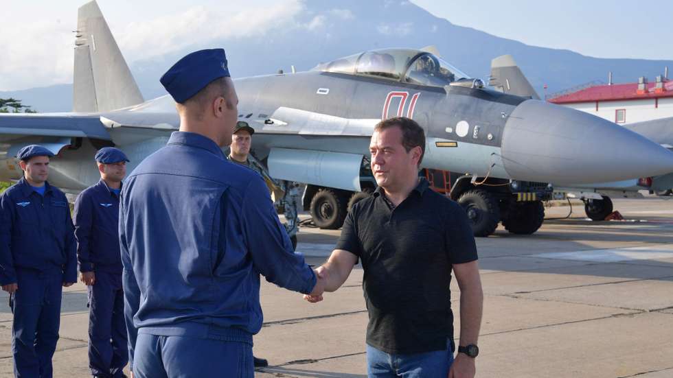 epa07753609 Russian Prime Minister Dmitry Medvedev (R) shakes hands with an air force officer at the Yasny airport on the Iturup island, the largest and northernmost island in Russia's southern Kurils, Russia, 02 August 2019.  EPA/ALEXANDER ASTAFYEV / GOVERNMENTAL PRESS SERVICE / POOL MANDATORY CREDIT/SPUTNIK
