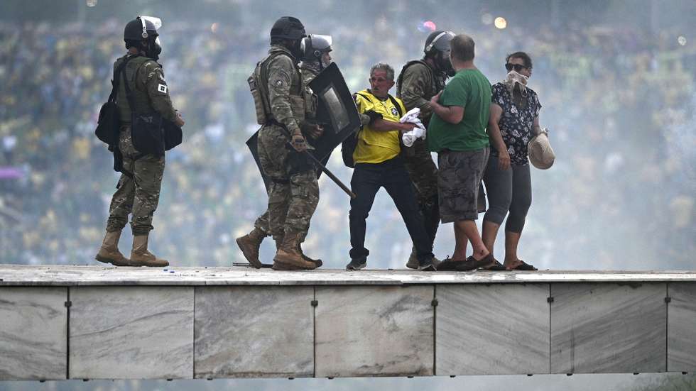 epaselect epa10396413 Police confront supporters of former Brazilian President Jair Bolsonaro invading Planalto Palace, in Brasilia, Brazil, 08 January 2023. Hundreds of supporters of former Brazilian President Jair Bolsonaro invaded the headquarters of the National Congress, and also Supreme Court and the Planalto Palace, seat of the Presidency of the Republic, in a demonstration calling for a military intervention to overthrow President Luiz Inacio Lula da Silva. The crowd broke through the cordons of security forces and forced their way to the roof of the buildings of the Chamber of Deputies and the Senate, and some entered inside the legislative headquarters.  EPA/ANDRE BORGES