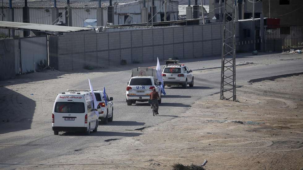 epa10930604 Cars of the UN and Palestine Red Crescent Society on the move as trucks carrying humanitarian aid for Gaza Strip enters from Egypt in Rafah, 21 October 2023. As Egypt is to host, on 21 October, an international summit about Gaza, and following the negotiations between Egypt, the US, and Israel to allow relief aid to enter the Gaza Strip, some 20 aid trucks carrying food, water, and medicine have been allowed into the Gaza Strip through the Rafah land crossing on 21 October. The move comes after days during which trucks were blocked on the Egyptian side of the Rafah border crossing. Egypt's Foreign Ministry had requested that the Isareli strikes on the area near the Gaza side of the border crossing stop, in order to allow the passage of the aid.  EPA/HAITHAM IMAD