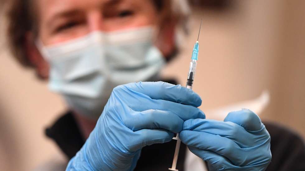 epa09618784 A pharmacy worker prepares a Covid-19 booster jab at the St John's Church Vaccination Centre in London Britain, 03 December 2021. A UK trial of seven different jabs finds that Pfizer and Moderna vaccines give the best overall booster response. A year ago the UK was the first country to approve the Pfizer-BioNTech vaccine.  EPA/NEIL HALL