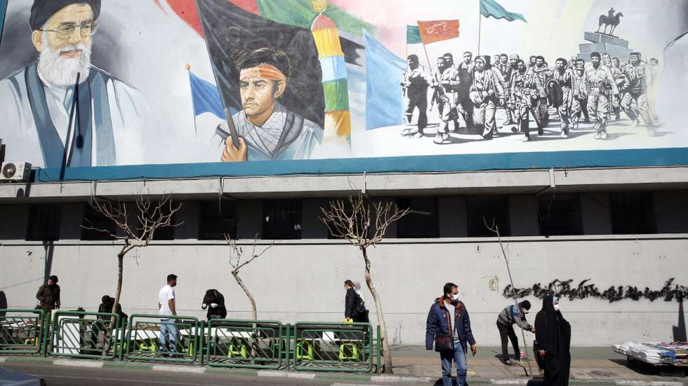 epa09030942 Iranians walk under a wall painting of Iranian supreme leader Ayatollah Ali Khamenei (Top-L) in Tehran, Iran, 23 February 2021. According to the law passed by the Iranian parliament earlier, Iranian government stopped extra inspection from its nuclear facilities by IAEA inspectors as of 23 February 2021 for three months until they reach a new agreement by lifting the US sanctions. IAEA chief Rafael Grossi said a temporary agreement was reached with Iranian government to allow a degree of monitoring until resolving disagreements and restore the 2015 nuclear deal. Iranian supreme leader Ayatollah Khamenei said that if Iran would need to enrich uranium even to 60 percent, the country would do it for its energy system and everything in need, not for building nuclear bombs which would be against one's beliefs and Islam.  EPA/ABEDIN TAHERKENAREH