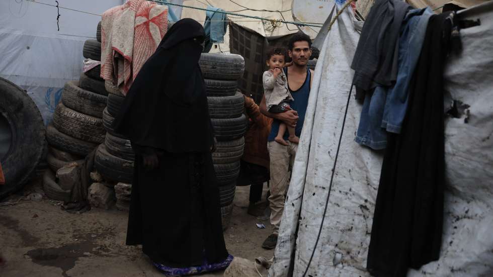 epa12802454 Displaced people stand next to their shelter at a makeshift camp for Internally Displaced Persons (IDPs) in Sana'a, Yemen, 07 March 2026. The World Food Programme (WFP) has warned of an escalating food security crisis in Yemen, with 63 percent of households nationwide struggling to meet their minimum food needs.  EPA/YAHYA ARHAB