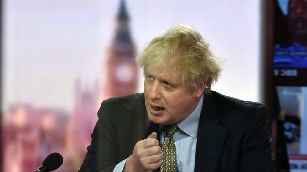 epa08916424 A handout photo made available by the British Broadcasting Corporation (BBC) shows Britain's Prime Minister Boris Johnson appearing at the Andrew Marr show in the BBC studios in London, Britain, 03 January 2021. Johnson said during the interview that Boris Johnson told the BBC that Britain may be facing tougher measures in weeks ahead as the nation battles the ongoing COVID-19 coronavirus pandemic.  EPA/JEFF OVERS HANDOUT ATTENTION EDITORS: PICTURE TAKEN THROUGH GLASS HANDOUT EDITORIAL USE ONLY/NO SALES