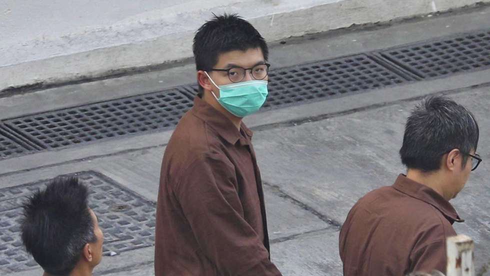 epa09180128 (FILE) - Pro-democracy activist Joshua Wong Chi-fung (C) walks in prisoner uniform at the Lai Chi Kok Reception Centre in Hong Kong, China, 03 December 2020 (reissued 06 May 2021). Wong, currently serving jail time over another protest-related case, was sentenced to 10 more months in prison on 06 May for participating in an unauthorised assembly on 04 June 2020 to mark China's 1989 Tiananmen protest crackdown.  EPA/JEROME FAVRE