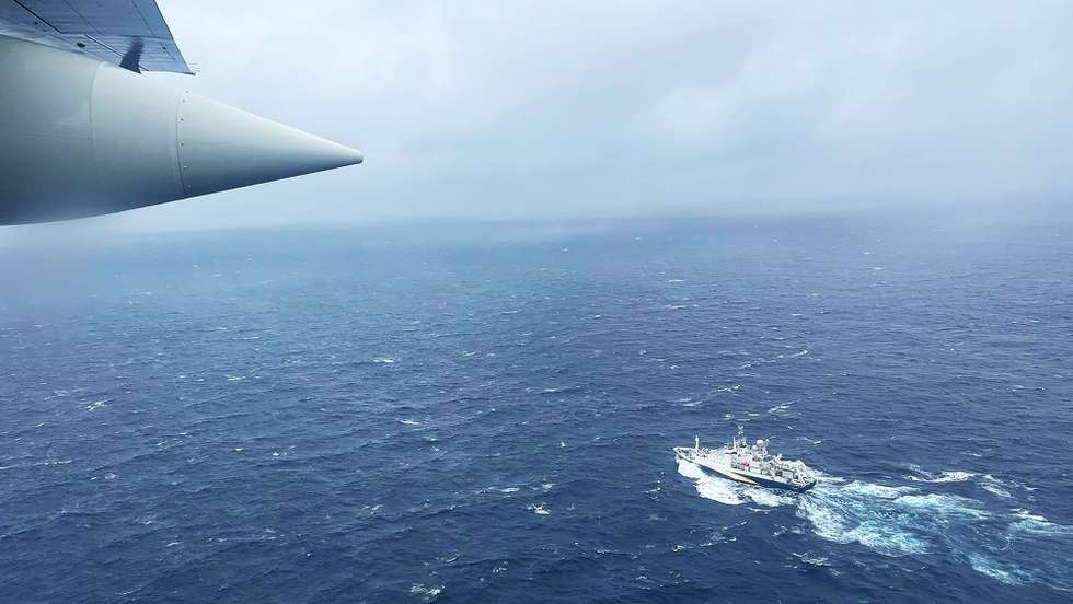 epa10706581 A handout photo made available by the US Coast Guard shows a Coast Guard Air Station Elizabeth City, North Carolina HC-130 Hercules airplane flies over the French research vessel, L'Atalante approximately 900 miles East of Cape Cod during the search for the 21-foot submersible, Titan, in Boston, Massachusetts, USA, 21 June 2023 (issued 22 June 2023). The United States Coast Guard, along with Canadian authorities, is searching the ocean depths for a submersible with Ocean Gate Expeditions, carrying tourists visiting the Titanic wreckage, 900 miles (1500 km) off the coast of Cape Cod, that lost contact on 18 June 2023.  EPA/PETTY OFFICER 1ST CLASS AMBER HOWIE HANDOUT  HANDOUT EDITORIAL USE ONLY/NO SALES