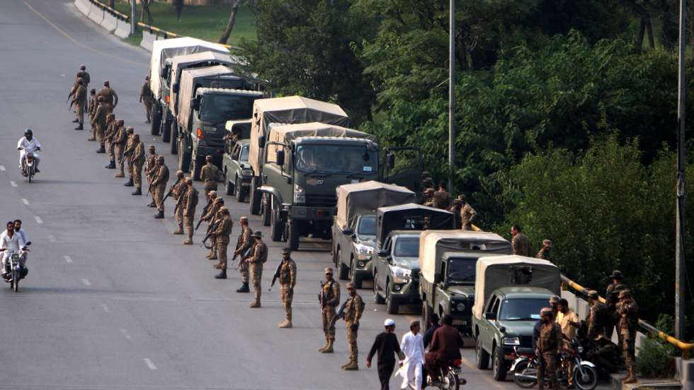 epa11643567 Pakistani army soldiers stand guard as supporters of Pakistan's former prime minister Imran Khan continued their protest for the second day, calling for Khan's release from prison in Islamabad, Pakistan, 05 October 2024. Mobile networks were suspended in Islamabad and Rawalpindi, as authorities blocked all entry points to the cities ahead of a planned rally by the Pakistan Tehreek-e-Insaf (PTI) party, despite a ban on gatherings. Former Prime Minister Imran Khan, currently imprisoned, called on his supporters to participate in a 'peaceful protest' at D-Chowk, emphasizing the need to oppose what he termed the 'illegal' nature of his imprisonment and the delay in implementing the Election Commission of Pakistan's reserved seats verdict. The PTI has held multiple rallies nationwide recently to advocate for constitutional rights and freedom of assembly.  EPA/SOHAIL SHAHZAD