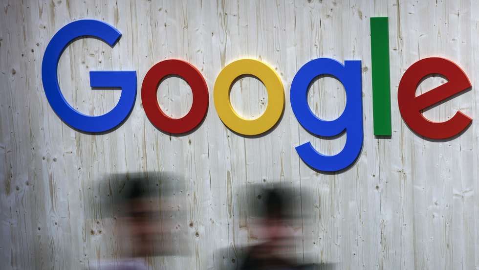 epa11293786 People pass a Google logo as they attend the annual industry trade fair 'Hannover Messe', in Hanover, Germany, 22 April 2024. Around 4000 exhibitors from the mechanical engineering, electrical and digital industries as well as the energy sector will showcase their latest technologies, developments and solutions at the fair from 22 to 26 April 2024. The fair will focus on climate protection, sustainability and artificial intelligence.  EPA/HANNIBAL HANSCHKE
