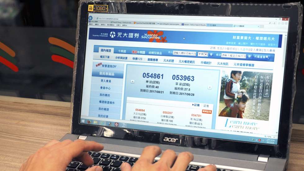 epa05769344 A man browses the website of Yuanta Securities in Taipei, Taiwan, early 04 February 2017. On 03 Feburary 2017, five Taiwan security companies suffered distributed Denial -of-service (DDoS) attacks from an anonynous hacker who demanded each firm to pay 170,000 Taiwan dollars (about 5,600 US dollars) in Bitcoin, or it would plant Trojan Horse programme in their computer systems. The attack halted or slowed down online trading temporarily, according to the CNYE news portal. The Financial Supervisory Commission urged securities firms to boost cyber security and to increase bandwidth. The securites firms affected by the hacking are MasterLink,, Yuanta, Capital, KGI and Tachan, CNYE news portal said.  EPA/DAVID CHANG