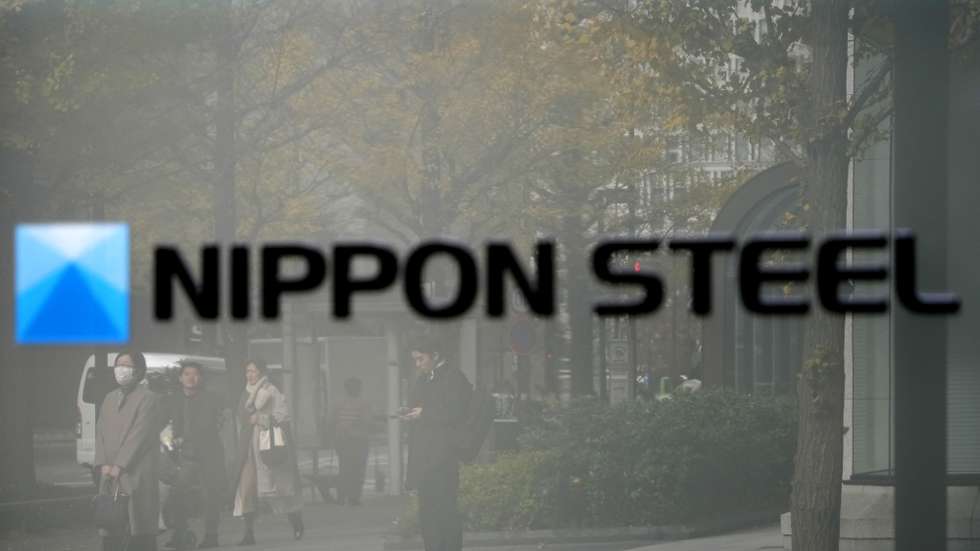 epa11036694 Passersby are reflected in the signage for Nippon Steel Corp. in front of the building housing the company's headquarters, in Tokyo, Japan, 19 December 2023. On late 18 December 2023, Nippon Steel Corp. (NSC) announced it decided to acquire United States Steel Corporation for around 14 billion US dollar.  EPA/FRANCK ROBICHON