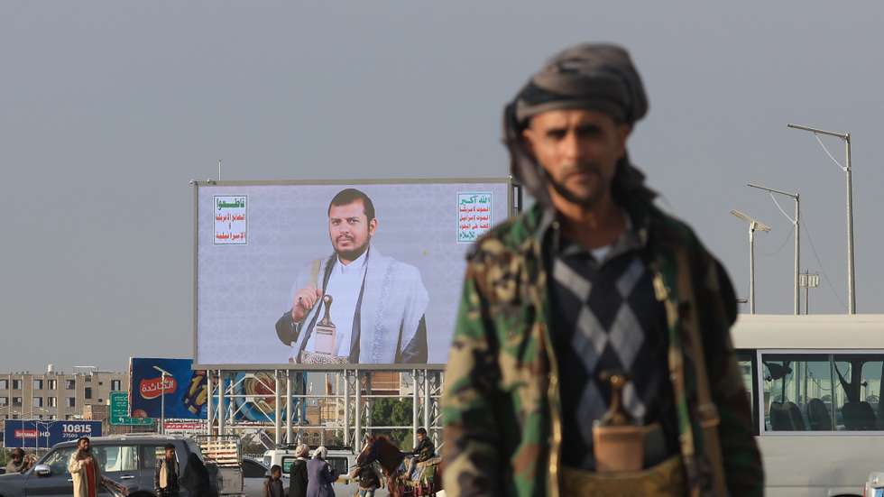 epaselect epa11972662 People walk past a digital billboard featuring the Houthis' leader, Abdul-Malik al-Houthi, in Sana'a, Yemen, 18 March 2025. Yemen's Houthis have condemned Israel's resumption of attacks against the Gaza Strip, vowing to escalate their military operations against Israel until its war on Gaza stops, the Houthis' Political Bureau said in a statement.  EPA/YAHYA ARHAB