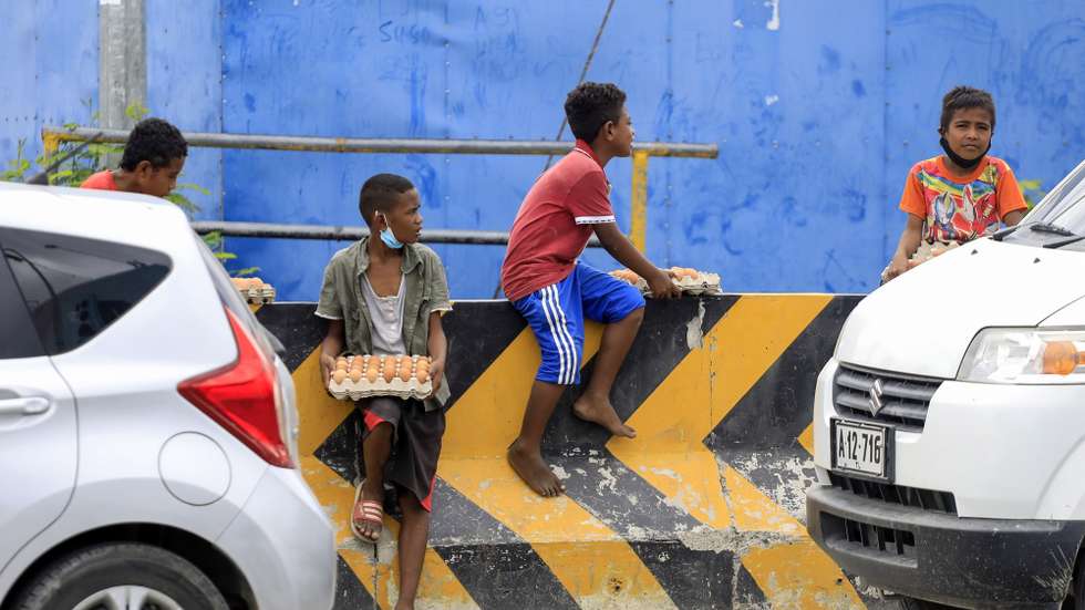 epa09444632 Street vendors offer eggs for sale on a road side in Dili, East Timor, also known as Timor Leste, 03 September 2021. According to the Asian Development Bank (ADB), the country’s economy is expected to grow in 2021 and 2022 amid the surge of COVID-19, driven by the government's economic recovery plan and public investments. East Timor has recorded more than 16,000 coronavirus disease (COVID-19) cases since the beginning of the pandemic.  EPA/ANTONIO DASIPARU