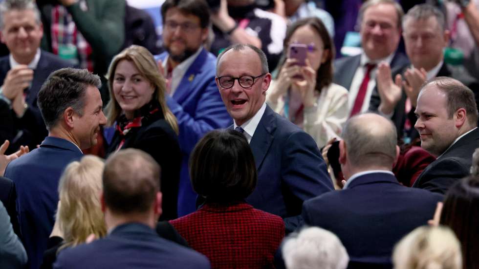 epa12762888 German Chancellor Friedrich Merz (C) reacts after his election for the chairman of CDU during the 38th Federal party convention of Democratic Union (CDU) party in Stuttgart, Germany, 20 February 2026. The federal party convention takes place from 19 to 21 February in Stuttgart.  EPA/RONALD WITTEK