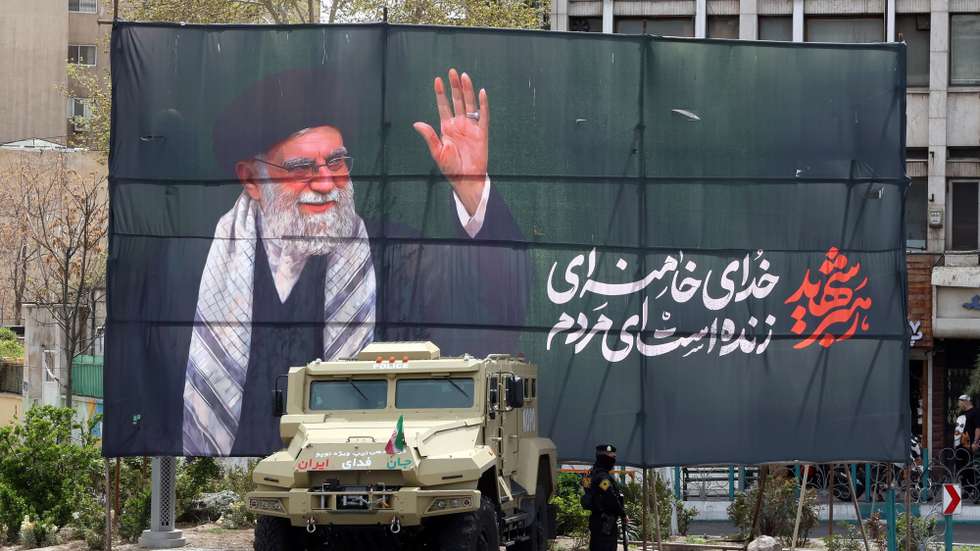 epaselect epa12860084 A member of the Iranian security forces stands guard next to a banner honouring former Iranian supreme leader Ali Khamenei, in Tehran, Iran, 30 March 2026. A joint US and Israeli military operation, launched on 28 February, continues to target strategic sites across Iran.  EPA/ABEDIN TAHERKENAREH