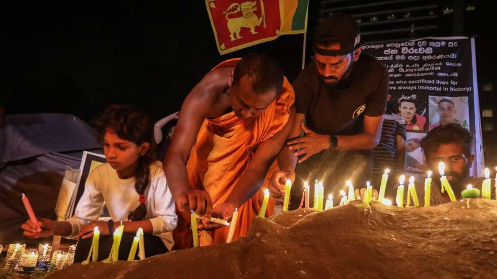 epa10074757 People light candles in memory of the protesters who were allegedly killed or wounded during the months-long protests and clashes against the economic crisis, near the Presidential Secretariat in Colombo, Sri Lanka, 16 July 2022. The Parliament of Sri Lanka accepted the resignation of President Gotabaya Rajapaksa after he fled to Singapore through the Maldives following months of anti-government protests fueled by the ongoing economic crisis. Protests have been rocking the country for over four months as Sri Lanka faces its worst-ever economic crisis in decades due to the lack of foreign reserves, resulting in severe shortages in food, fuel, medicine, and imported goods.  EPA/CHAMILA KARUNARATHNE