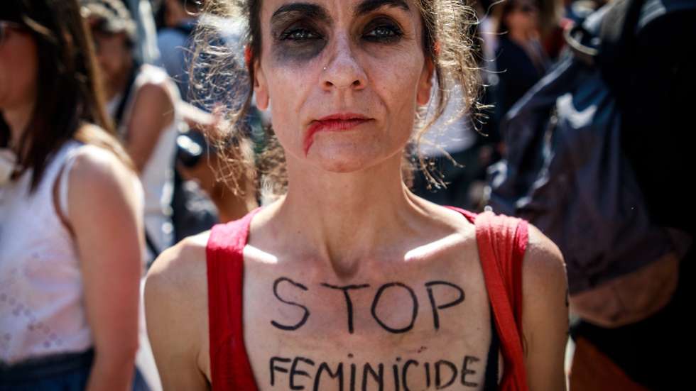 epa07699655 A feminist activists poses with a slogan 'Stop Femicide' during  a rally for the Elimination of Violence Against Women in Paris, France, 06 July 2019. Since January 2019, some 71 women in France have been killed, drawing alarm to the rising incidents of feminicide.  EPA/CHRISTOPHE PETIT TESSON