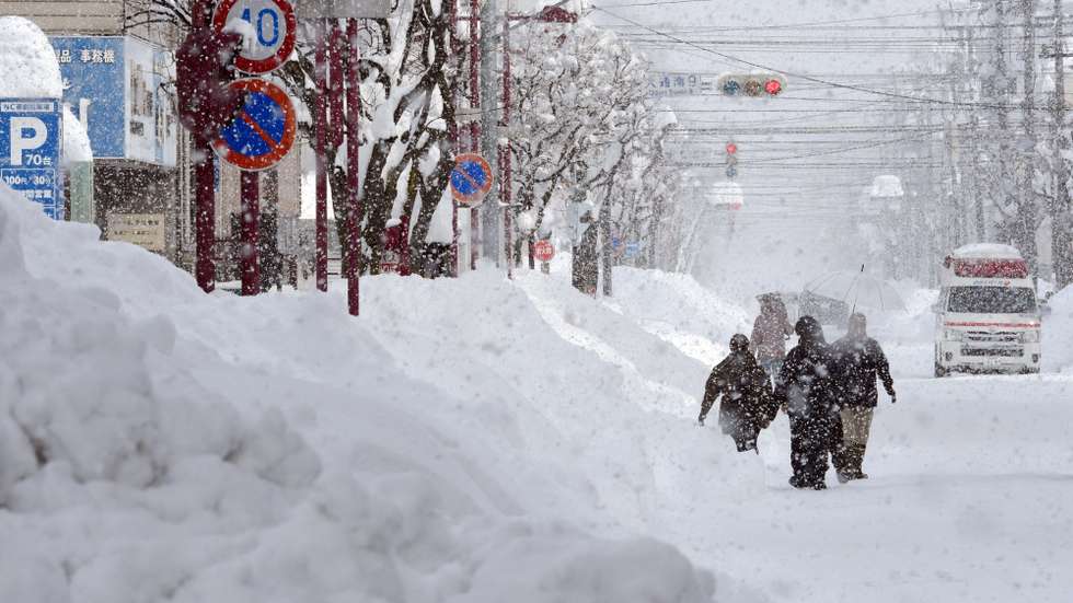 epa11875688 People walk in a street covered with snow following heavy snowfall in Obihiro, Hokkaido, northern Japan, 04 February 2025 (issued 05 February 2025). On 05 February 2025, the coldest air of the winter persisted over the Japanese archipelago, bringing heavy snowfall to Hokkaido and areas along the Sea of Japan coast. The cold front is expected to continue for several days, and the Japan Meteorological Agency (JMA) has issued warnings about heavy snow and blizzards, which already led to school closures and transportation disruptions.  EPA/JIJI PRESS JAPAN OUT EDITORIAL USE ONLY