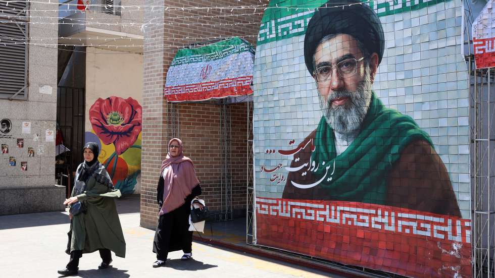 epaselect epa12970279 Iranians walk past a picture of Iranian supreme leader Ayatollah Mojtaba Khamenei in a street in Tehran, Iran, 18 May 2026. The conflict between Iran and the US continues as US President Donald Trump repeated threats of fresh military action against Iran.  EPA/ABEDIN TAHERKENAREH