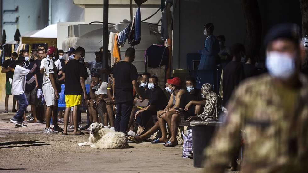 epa09460660 A view of migrants, who landed in Italy on the island of Lampedusa, in the hotspot of Lampedusa, Italy's southernmost island, 10 September 2021 (issued 11 September 2021). The Italian Ministry of the Interior announced on 09 September, the activation of two mini COVID-19 vaccination hubs on the island of Lampedusa -- manned by Army medical personnel -- with the function of completing the vaccination campaign of the island population and vaccinating the migrants received at the local hotspot.  EPA/ANGELO CARCONI -- ATTENTION EDITORS: IMAGE PIXELATED AT SOURCE