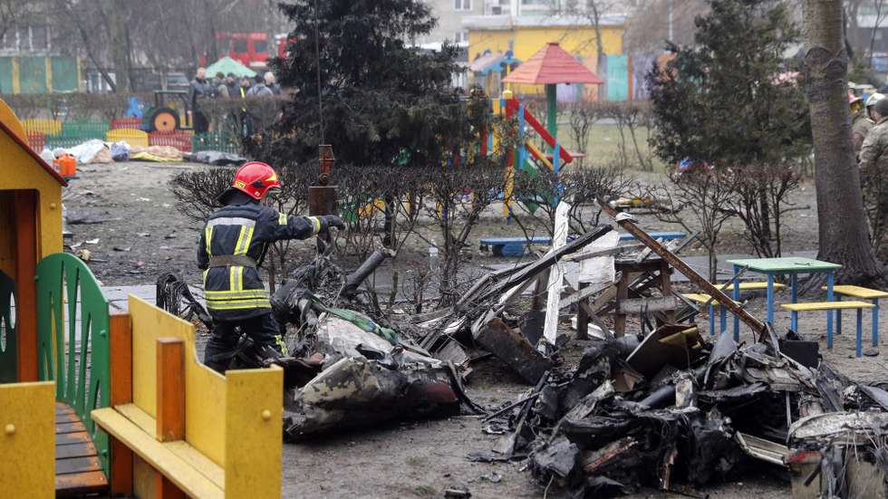 epa10413088 Rescue services remove debris of the helicopter at the scene of a helicopter crash in Brovary, near Kyiv, Ukraine, 18 January 2023. At least 18 people died, including three children, after a helicopter crashed near a kindergarten and a residential building in the city of Brovary, Oleksiy Kuleba, the head of Kyiv Regional Military Administration wrote on telegram. 'Among them are Minister of Internal Affairs of Ukraine Denys Monastyrskyi, his first deputy Yevhen Yenin, State Secretary of the Ministry of Internal Affairs Yuri Lubkovych, their assistants and the helicopter crew.', stated President of Ukraine Volodymyr Zelensky.  EPA/SERGEY DOLZHENKO