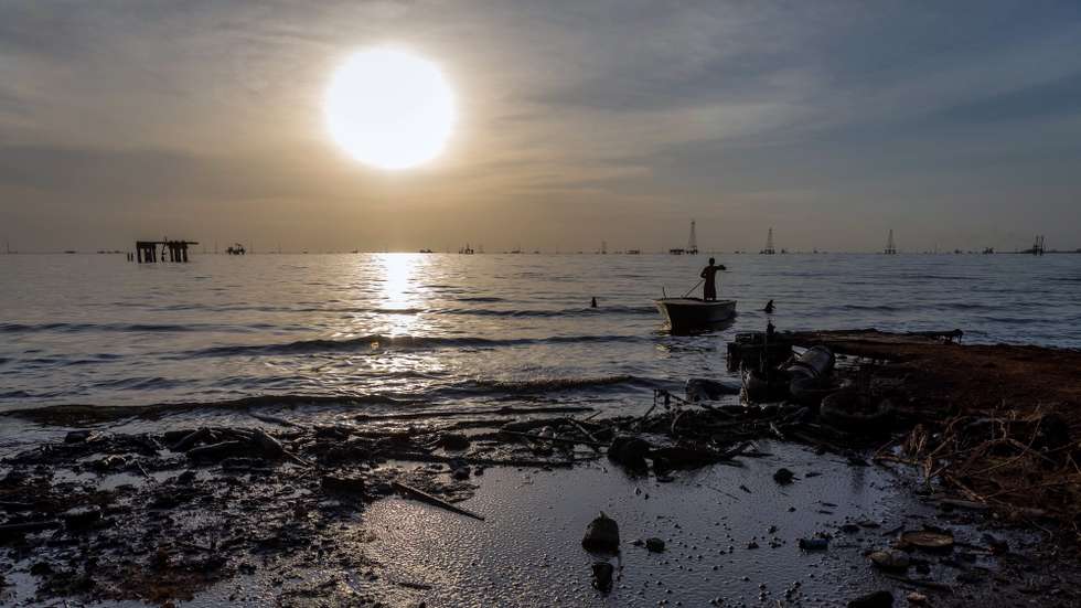 epa08048989 A fisherman navigates contaminated water in a boat for shrimp night fishing, in the R1 sector of Cabimas, Zulia state, Venezuela, 28 November 2019 (issued 06 December 2019). Lake Maracaibo has an area close to 12.958 square kilometers and is an important water resource, partly formed by the water sources of the hydrographic sub-basins. Also it is one of the oil deposits with the most proven oil reserves, which guarantees Venezuela to be the country with the largest reserves in the world, according to EIA data and the Bulletin of statistics on British Petroleum. This economic 'blessing', however, affects the natural physicochemical characteristics of the lake system and is a problem for its inhabitants who daily must fight against the contamination of their natural resources, rationing, state forgetfulness and poverty.  EPA/MIGUEL GUTIERREZ  ATTENTION: This Image is part of a PHOTO SET
