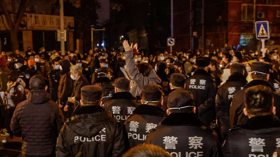 epa10333071 A man claps during a protest triggered by a fire in Urumqi that killed 10 people in Beijing, China, 27 November 2022. Protests against China's strict COVID-19 restrictions have erupted in various cities including Beijing and Shanghai, triggered by a tower fire that killed 10 people Xinjiangâ€™s capital, Urumqi.  EPA/MARK R. CRISTINO
