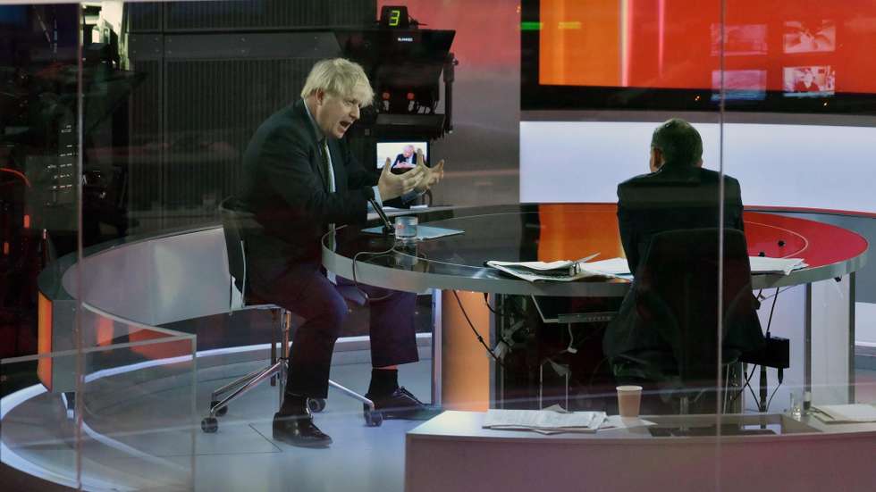 epa08916423 A handout photo made available by the British Broadcasting Corporation (BBC) shows Britain's Prime Minister Boris Johnson appearing at the Andrew Marr show in the BBC studios in London, Britain, 03 January 2021. Johnson said during the interview that Boris Johnson told the BBC that Britain may be facing tougher measures in weeks ahead as the nation battles the ongoing COVID-19 coronavirus pandemic.  EPA/JEFF OVERS HANDOUT ATTENTION EDITORS: PICTURE TAKEN THROUGH GLASS HANDOUT EDITORIAL USE ONLY/NO SALES