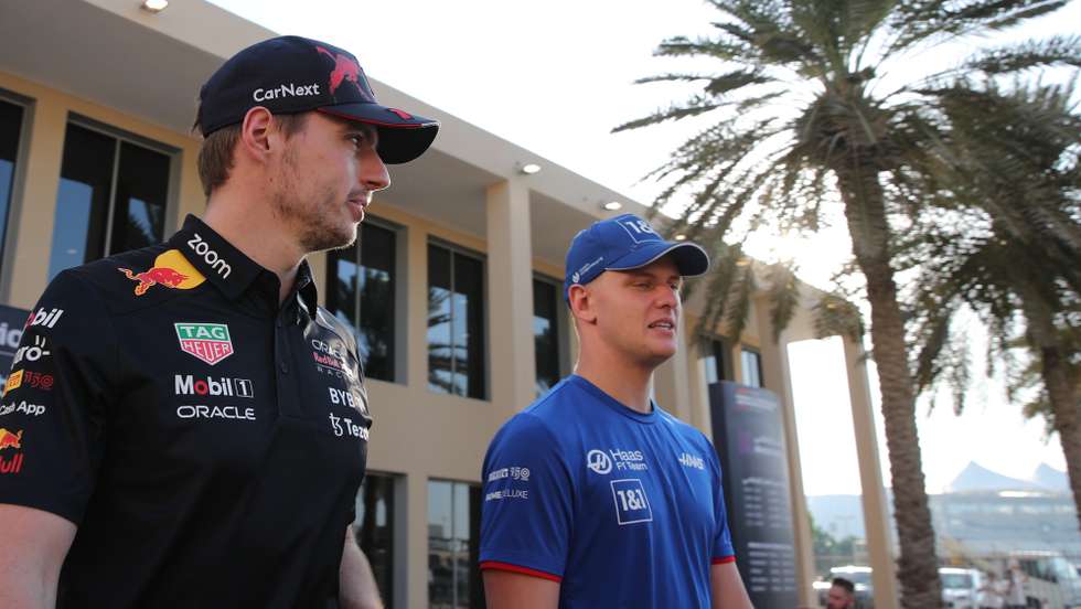 epa10310382 Dutch Formula One driver Max Verstappen (L) of Red Bull Racing and German driver Mick Schumacher (R) of the Haas F1 Team walk through the paddock ahead of the Abu Dhabi Formula One Grand Prix 2022 at Yas Marina Circuit in Abu Dhabi, United Arab Emirates, 17 November 2022. The Formula One Grand Prix of Abu Dhabi will take place on 20 November 2022.  EPA/ALI HAIDER