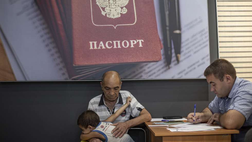 epa10116787 A picture taken during a visit to Berdyansk organised by the Russian military shows residents submitting documents at a center for the preparation of documents for the registration of Russian citizenship and passport application in Berdyansk, Zaporizhia region, Ukraine, 11 August 2022 (Issued 12 August 2022). The head of the Zaporizhia region, Yevgeny Balitsky, announced that he had signed an order to hold a referendum on the issue of joining the region to Russia in early September 2022. Twelve headquarters for preparations for a referendum on joining the Russian Federation opened in Berdyansk and Berdyansk district of Zaporizhia region, said the head of the military-civilian administration of Berdyansk and Berdyansk region Alexander Saulenko. The city of Berdyansk is located on the territory controlled by the troops of the Russian Federation and the city is administered by the Military-Civilian Administration controlled by Russia. On 24 February 2022 Russian troops entered the Ukrainian territory in what the Russian president declared a 'Special Military Operation', starting an armed conflict that has provoked destruction and a humanitarian crisis.  EPA/SERGEI ILNITSKY