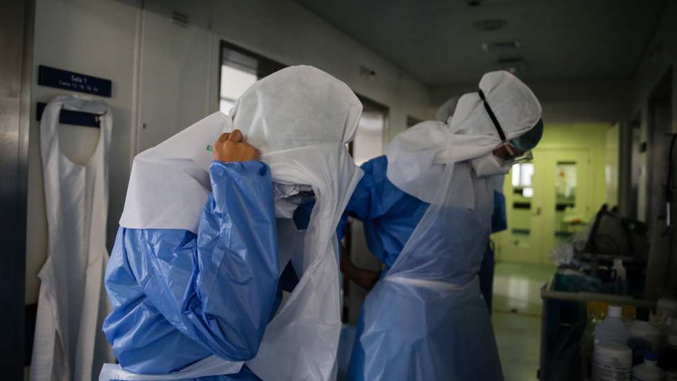 Enfermeiras preparam o seu material de proteção antes de cuidar dos seus pacientes na Unidade de Cuidados Intensivos Covid 19 do Hospital Santa Maria em Lisboa, 27 de outubro de 2020. A urgência dedicada aos casos suspeitos de covid-19 do Hospital Santa Maria, em Lisboa, reflete a evolução da pandemia em Portugal com doentes a avolumarem-se à porta para realizar o teste e no interior a capacidade quase esgotada. O medo de perder o emprego leva muitos doentes com covid-19 a esconderem que estão infetados e a continuar a trabalhar, disseminando a doença que, nesta fase, começa a ser um caso também social e que leva a muitos internamentos no Santa Maria. (ACOMPANHA TEXTO DA LUSA DE 30 DE OUTUBRO DE 2020) TIAGO PETINGA/LUSA