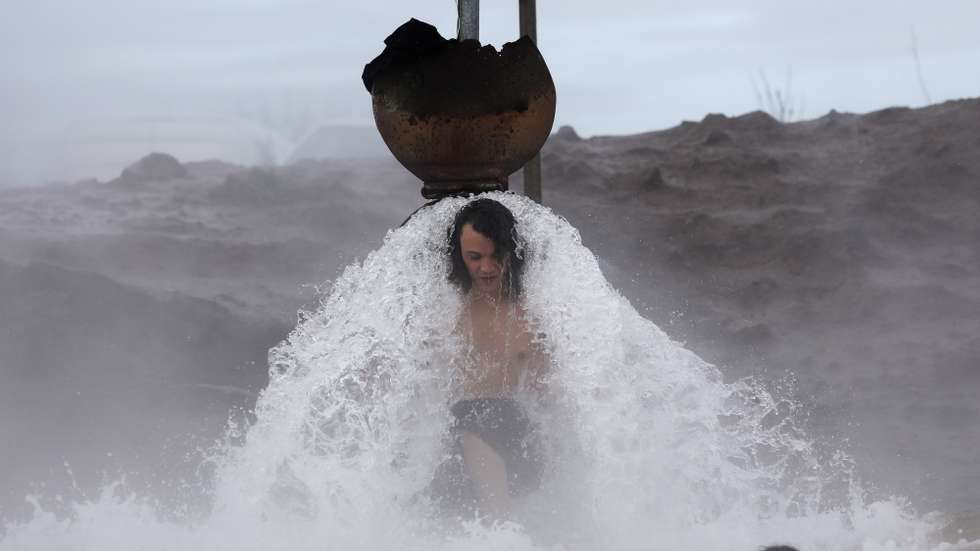 epa09662400 A person enjoys bathing in a hot water spring during a cold New Year's Day near Kibbutz Merom Golan in the Golan Heights, northern Israel , 01 January 2022.  EPA/ABIR SULTAN